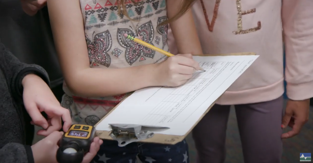 Students writing on clipboard